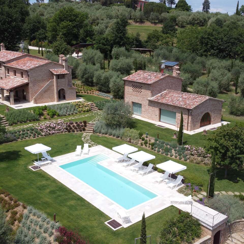 private swimming pool with sunbeds and umbrellas