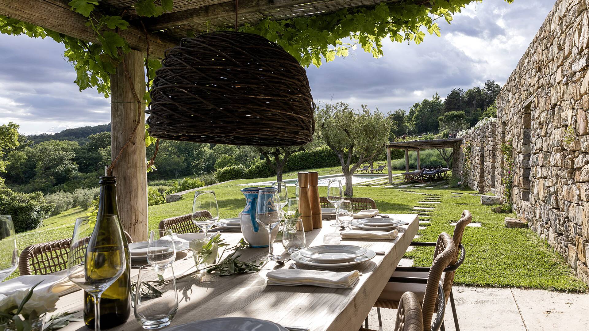 covered al fresco dining table by the private pool