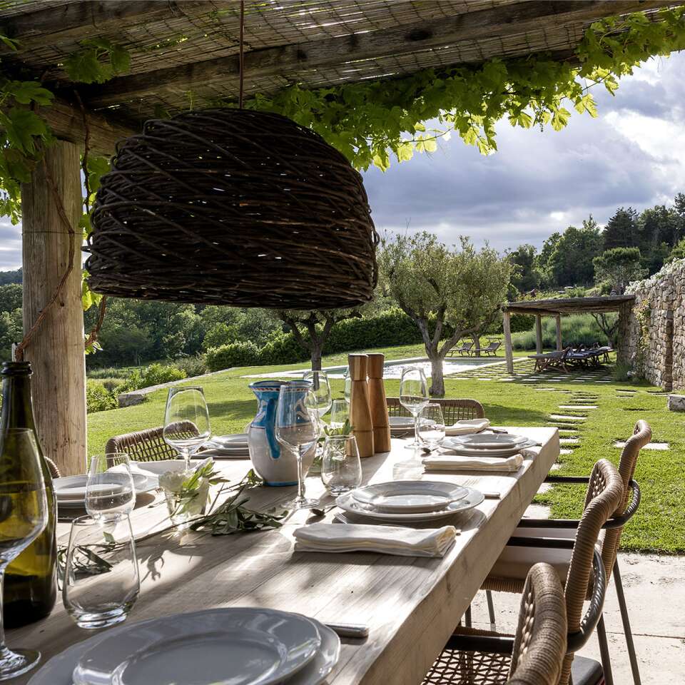 covered al fresco dining table by the private pool