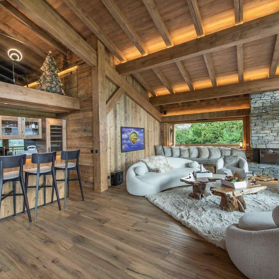 modern open space with sitting area, counter bar, fireplace and TV