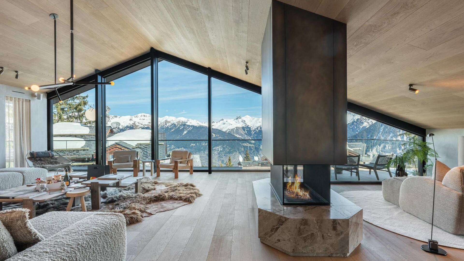 modern living room with central fireplace and contemporary French windows