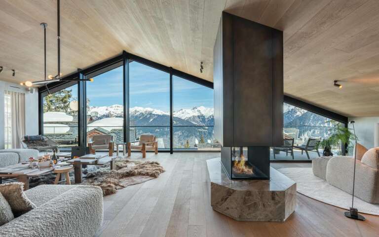 modern living room with central fireplace and contemporary French windows