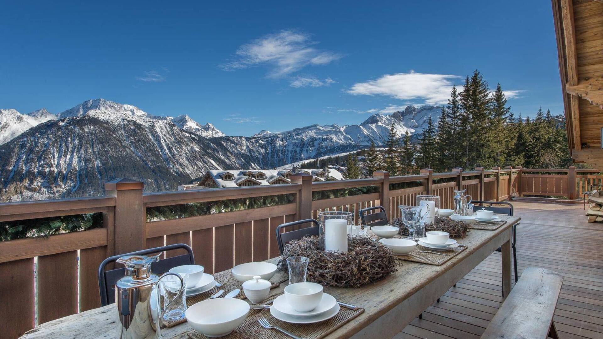 al fresco dining table with view over snowcapped French Alps