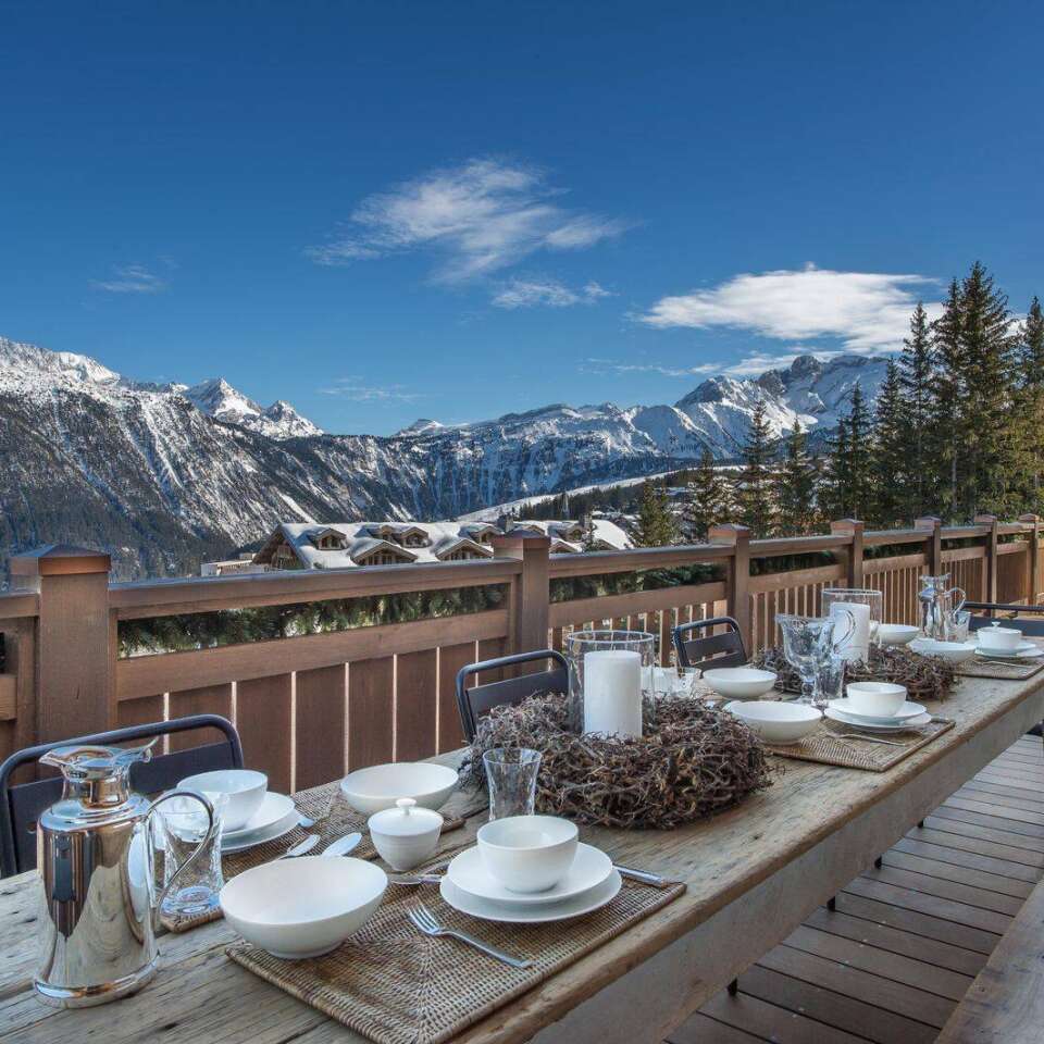 al fresco dining table with view over snowcapped French Alps