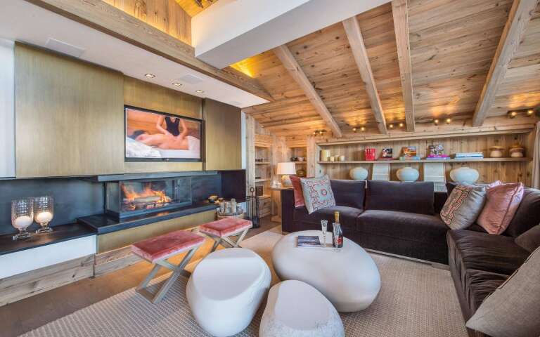 modern living room with large TV and wooden ceiling