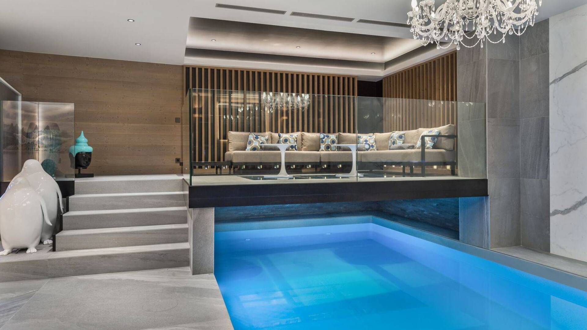 large indoor pool with lounge area on mezzanine floor