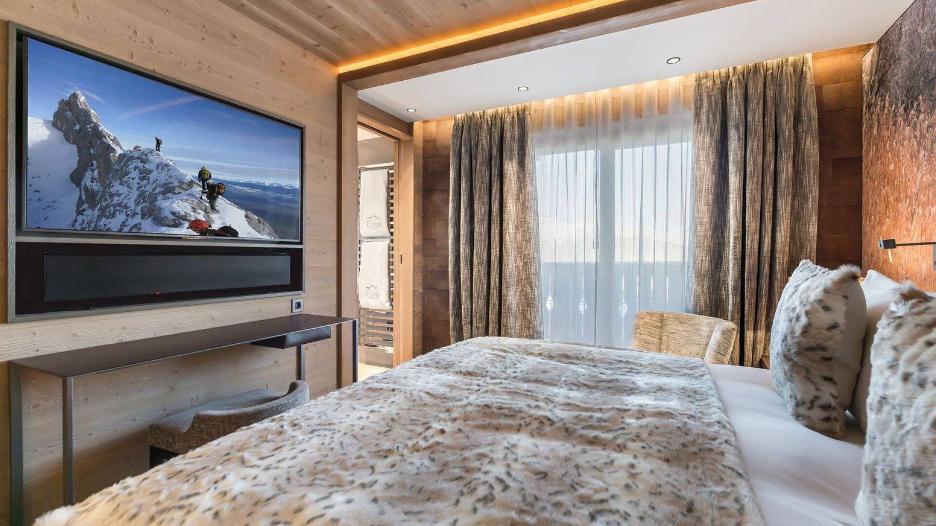 luxury double bedroom with TV and en suite bathroom
