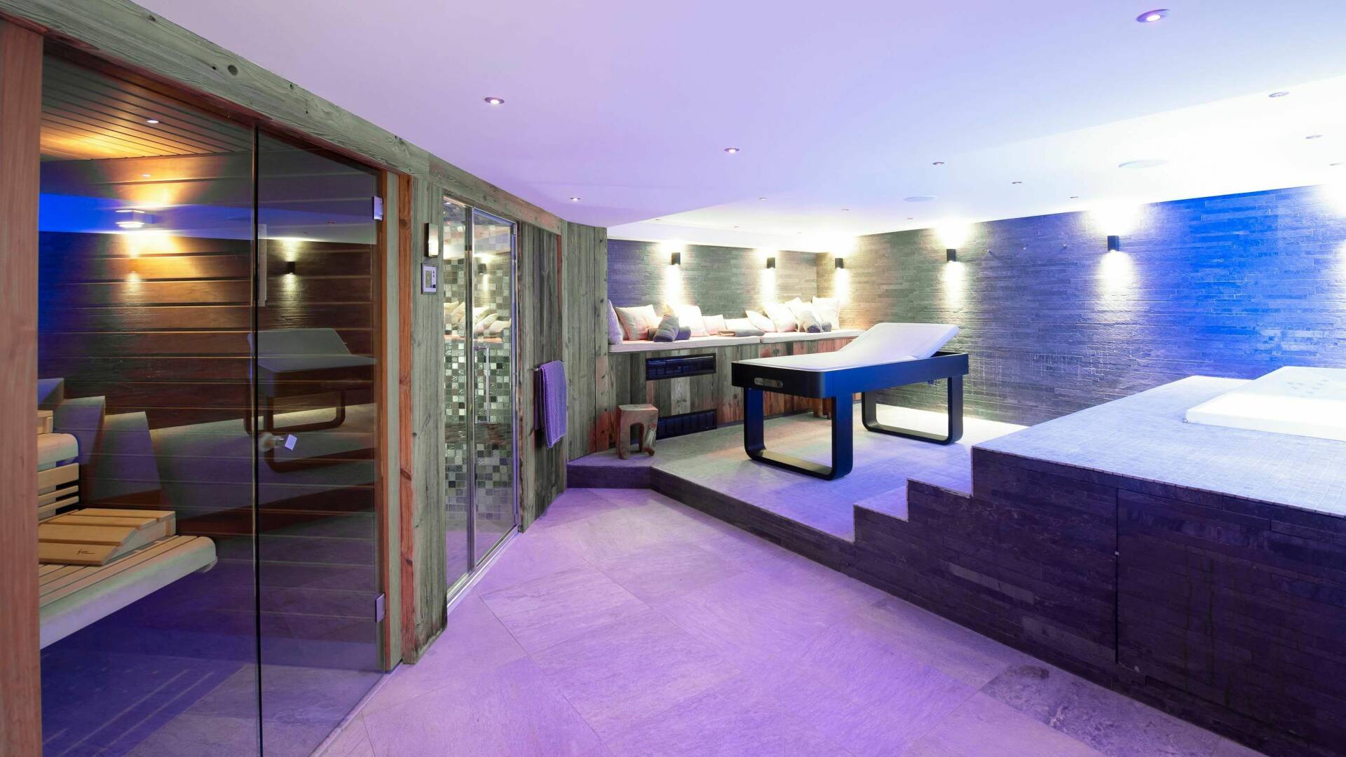 wellness area with indoor pool, massage bed and sauna