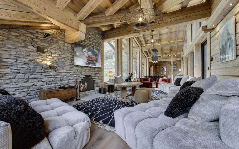 majestic living room with TV, cosy sofas and fireplace