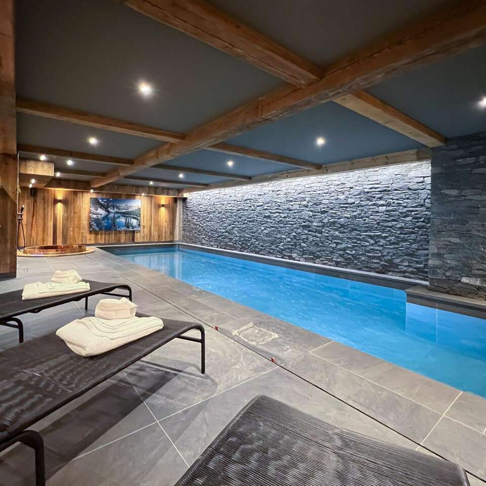 luxury indoor pool with sunbeds