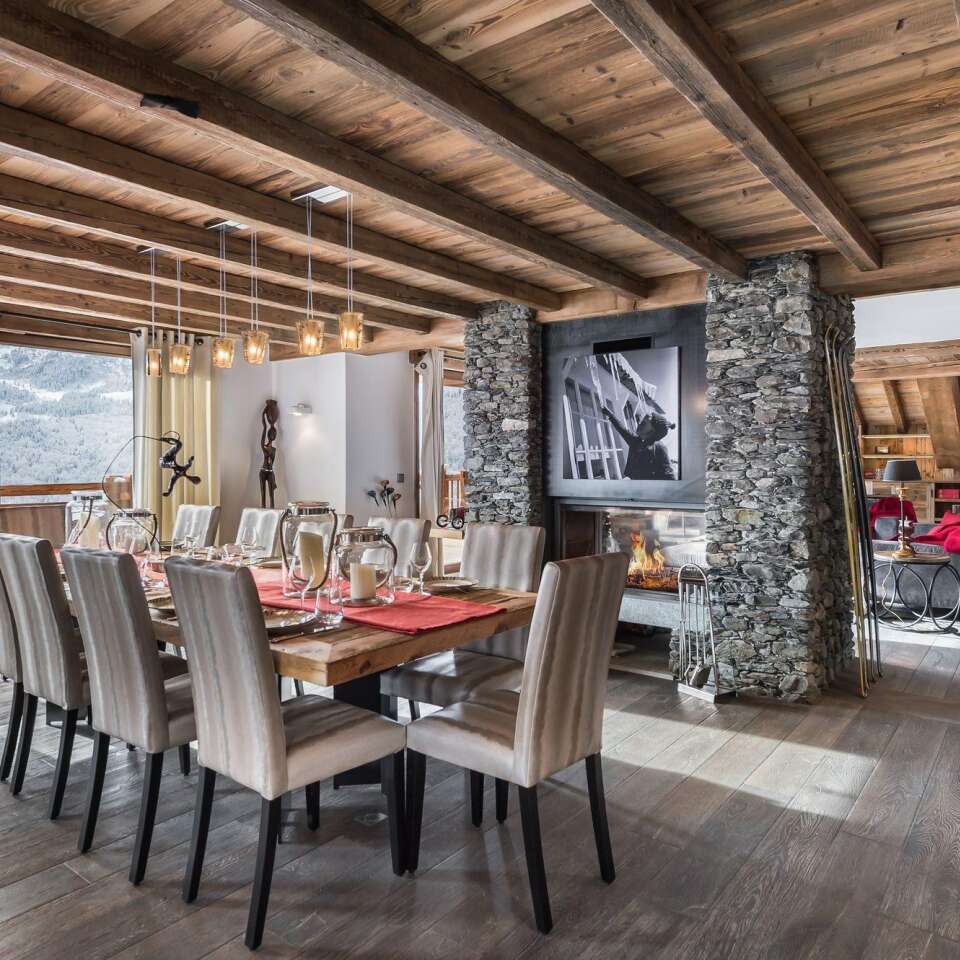 modern dining area with TV, fireplace and access to outdoor