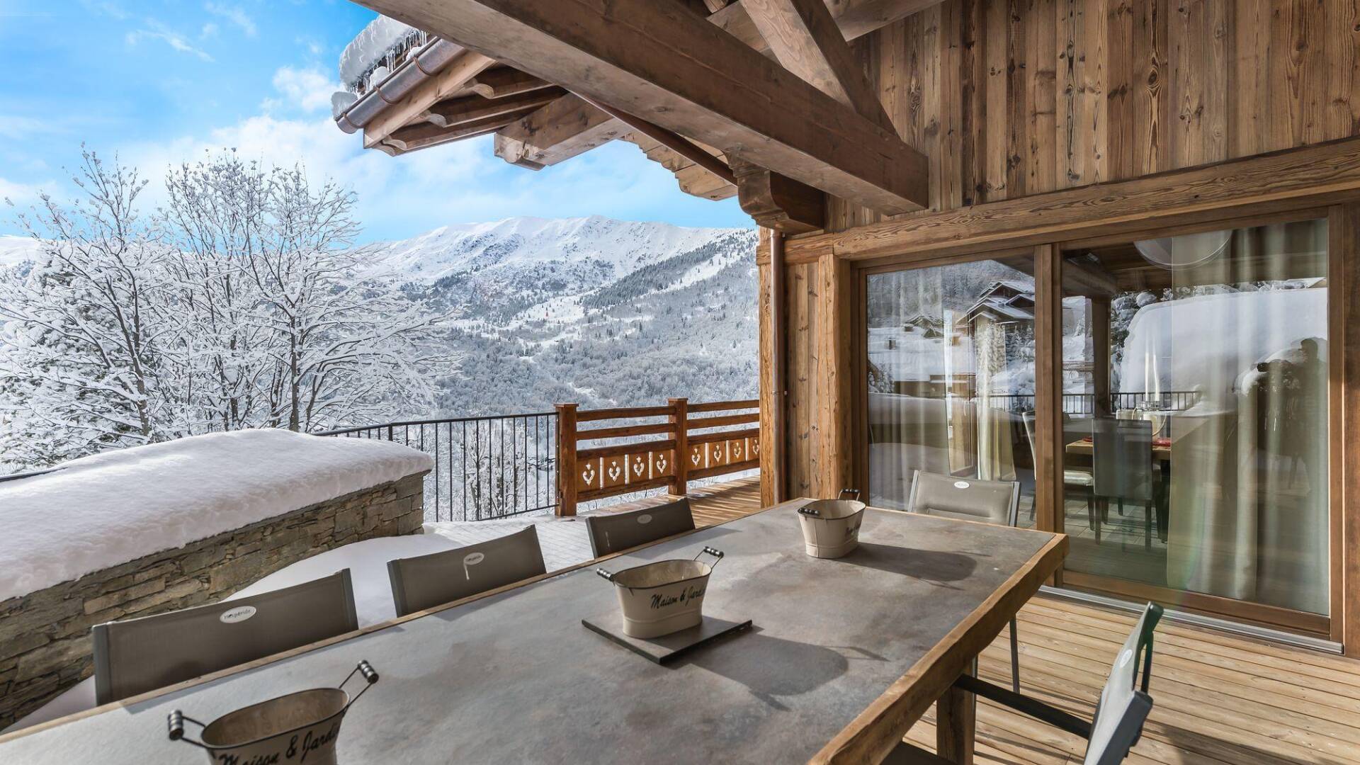 al fresco dining table with view over snowcapped French Alps