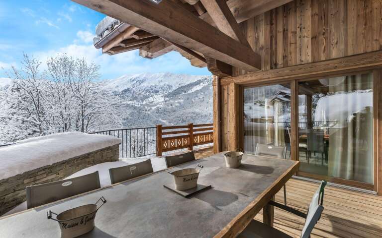 al fresco dining table with view over snowcapped French Alps