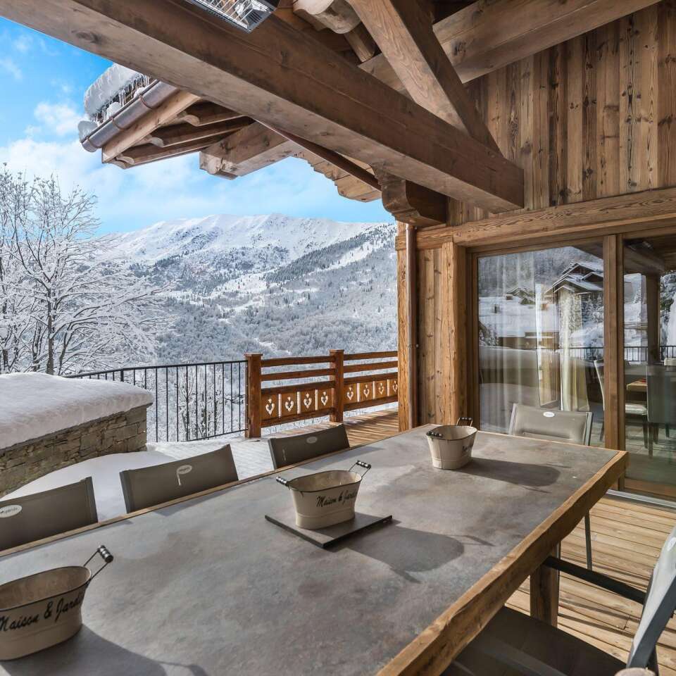al fresco dining table with view over snowcapped French Alps