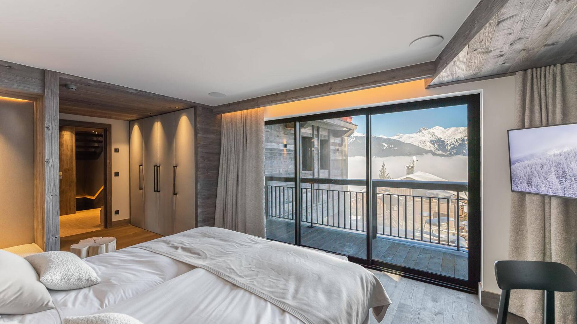double bedroom with French windows, TV, balcony and en suite bathroom