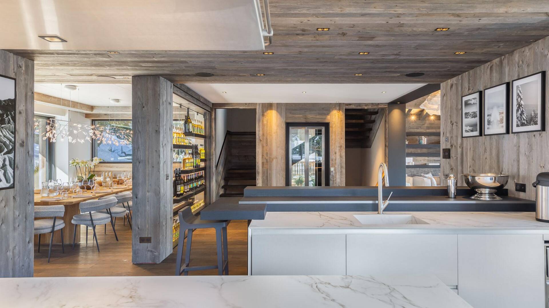 contemporary open space with gourmet kitchen, dining area and wine fridge