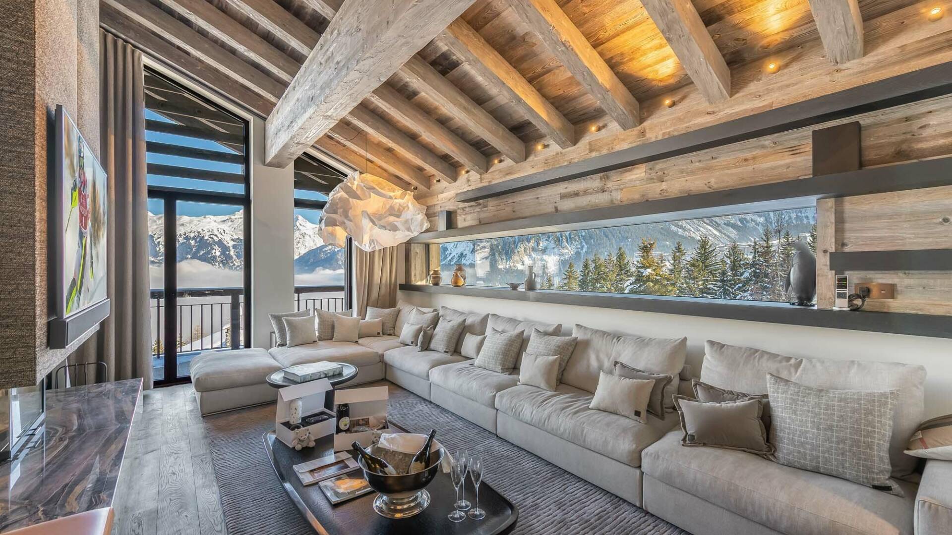 luxury living room with large sofa, TV and access to outdoor