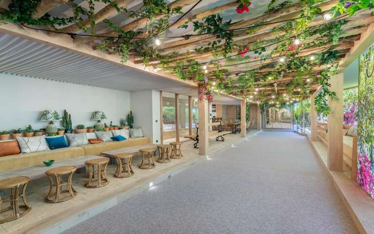 majestic covered sitting area with flowers and white sand