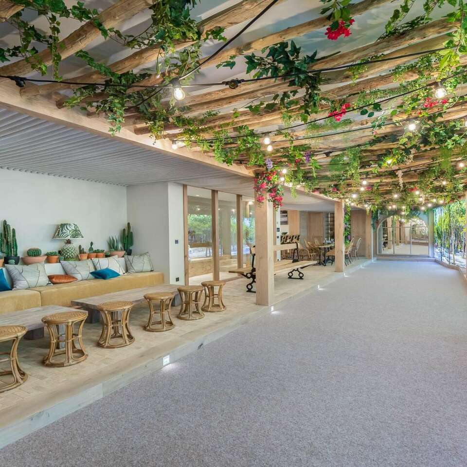 majestic covered sitting area with flowers and white sand