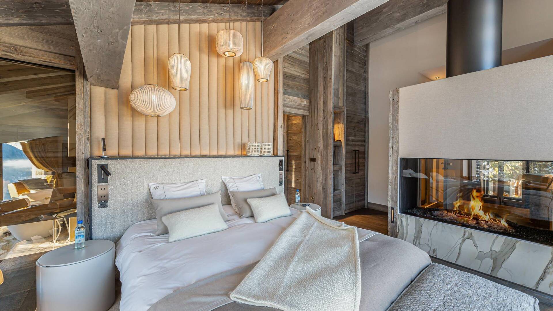 luxury double bedroom with large modern fireplace