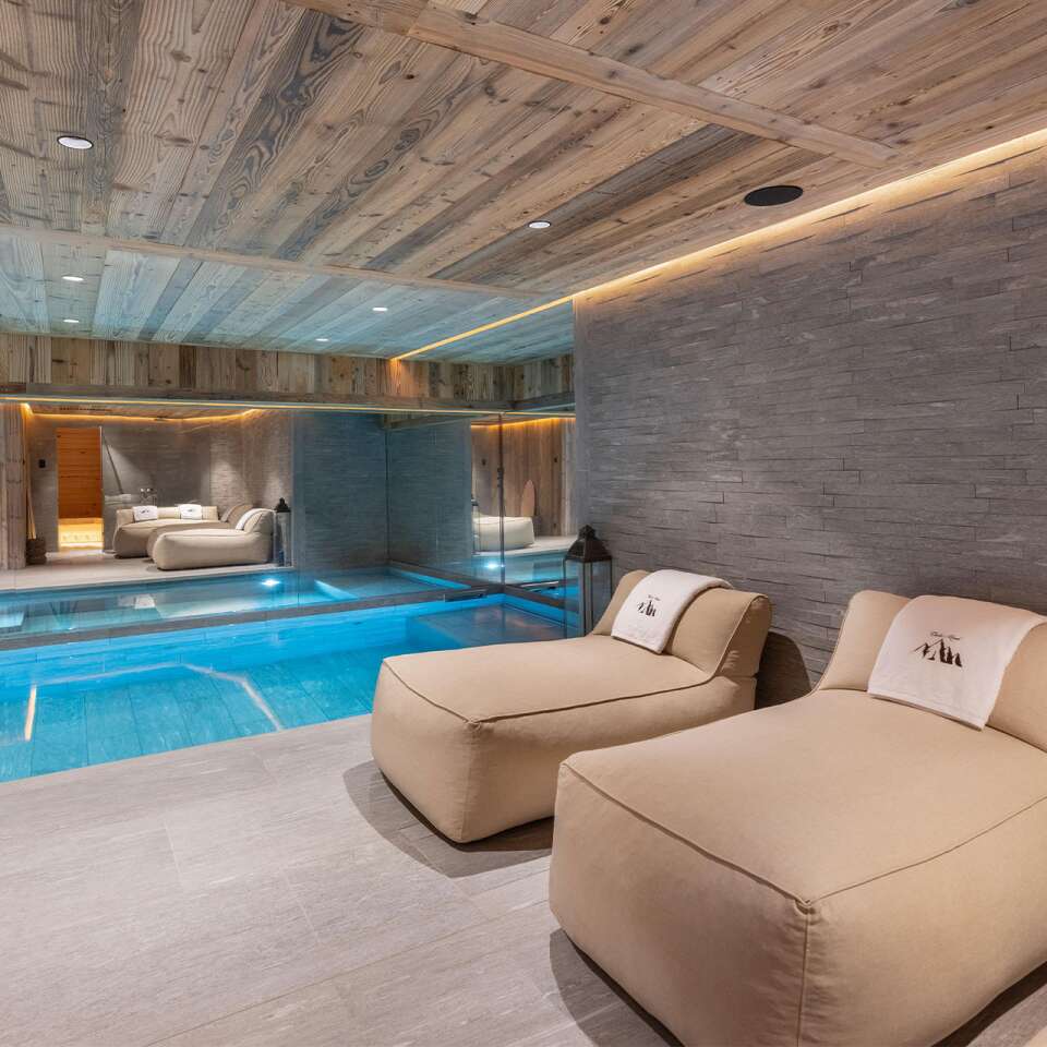 luxury indoor pool with cosy lounge area