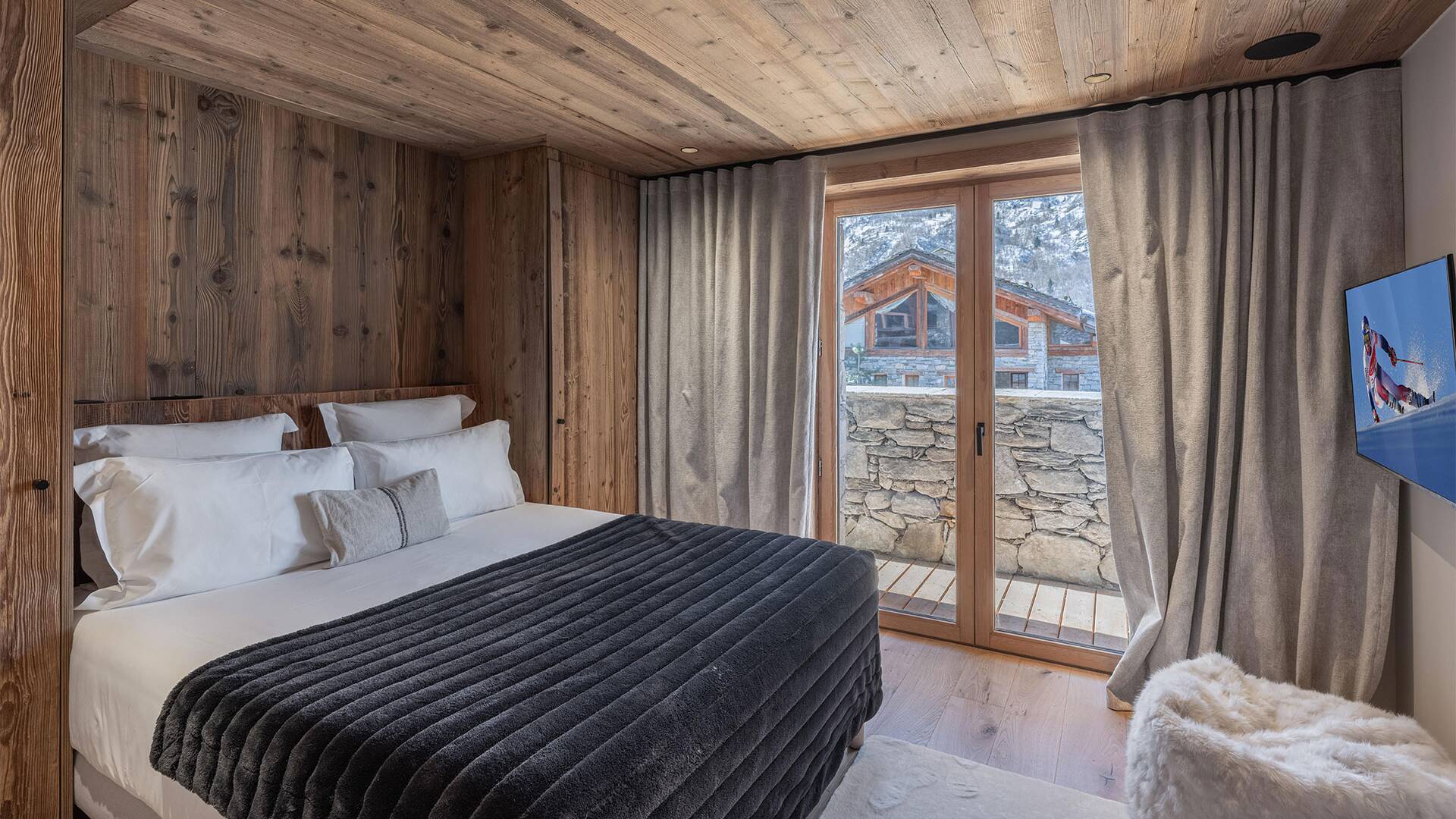 double bedroom with TV and access to balcony