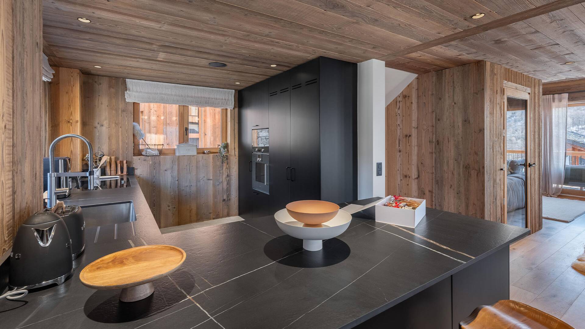 fully equipped black kitchen with induction hub and cooking island