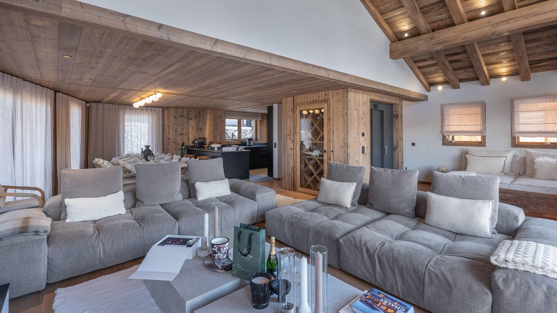 living room with cosy sofas, TV and floor-to-ceiling windows