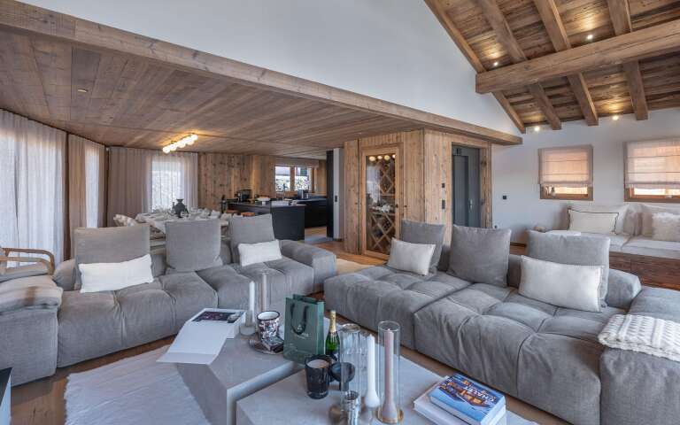 living room with cosy sofas, TV and floor-to-ceiling windows