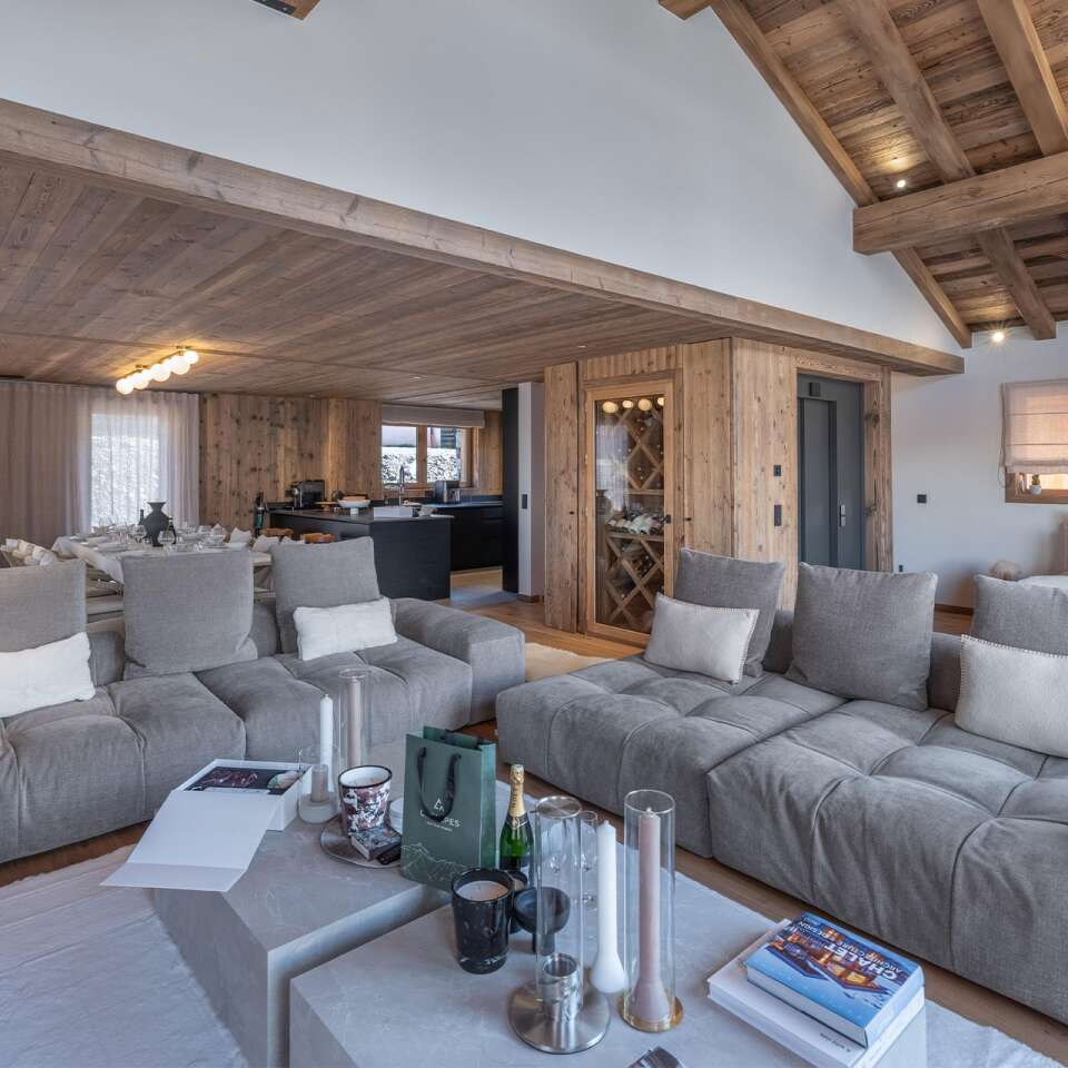 living room with cosy sofas, TV and floor-to-ceiling windows