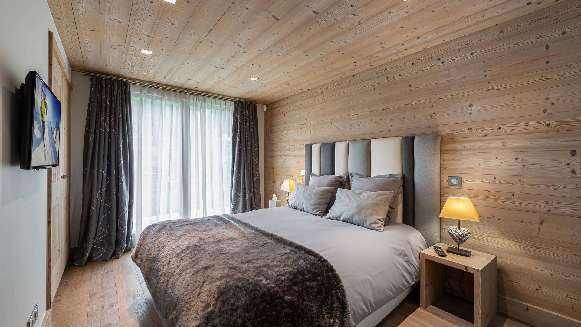 double bedroom with French windows and TV