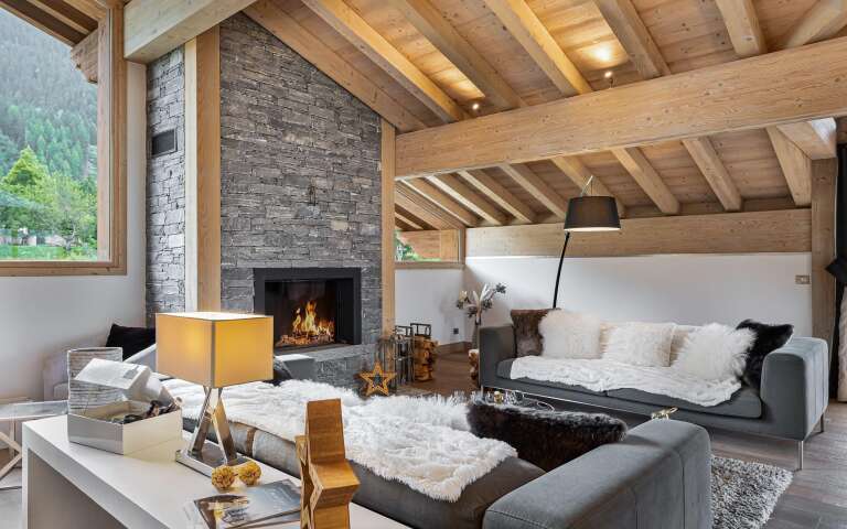 cosy living room with plush pillows and modern fireplace