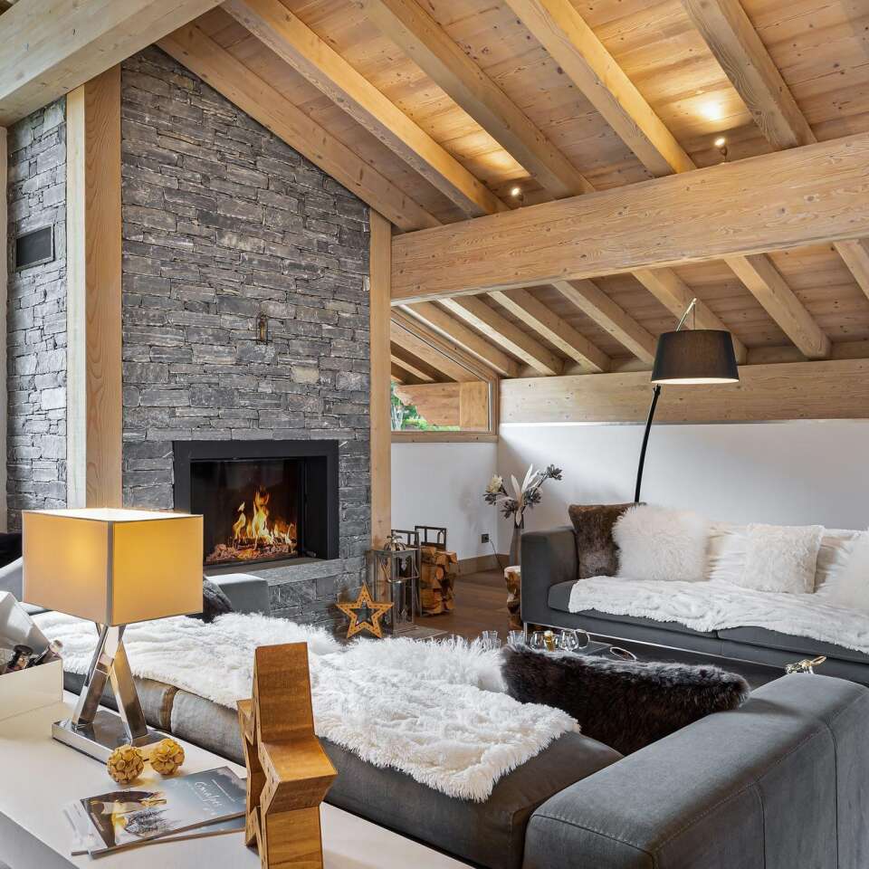 cosy living room with plush pillows and modern fireplace