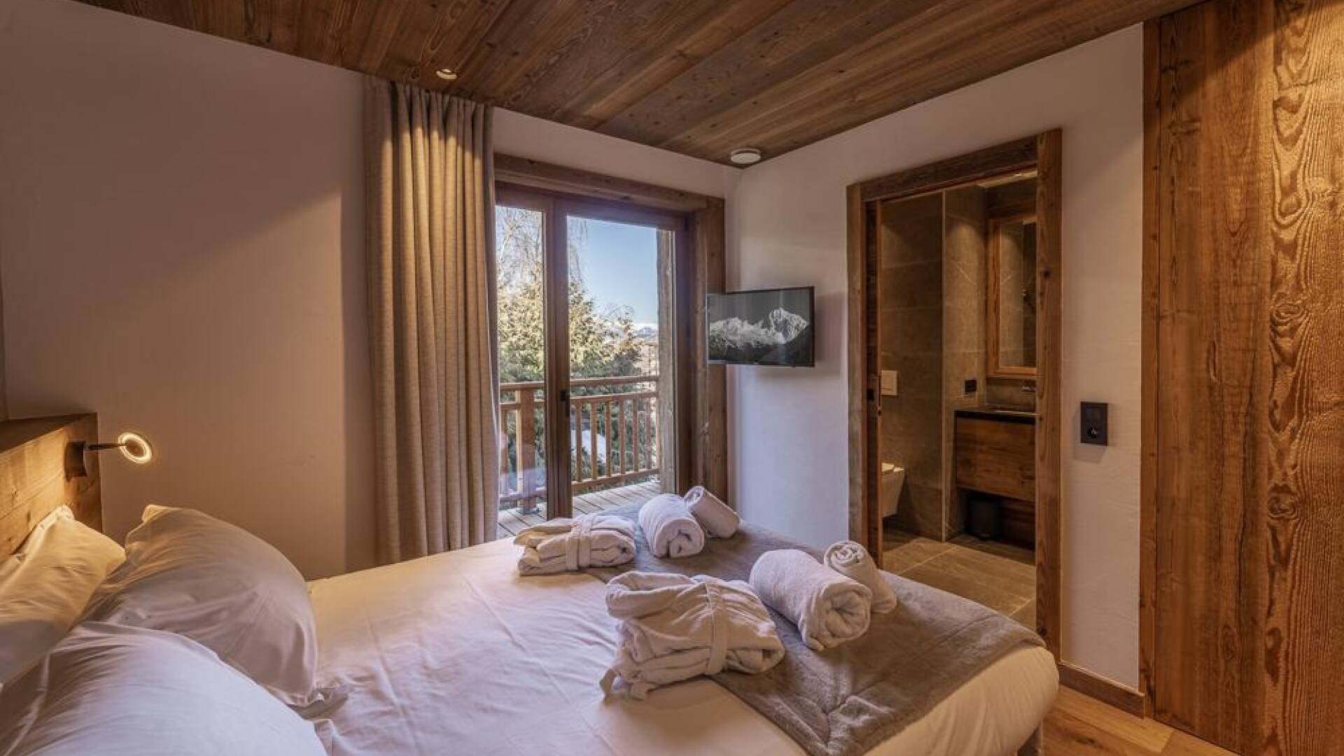 luxury double bedroom with access to balcony and en suite bathroom