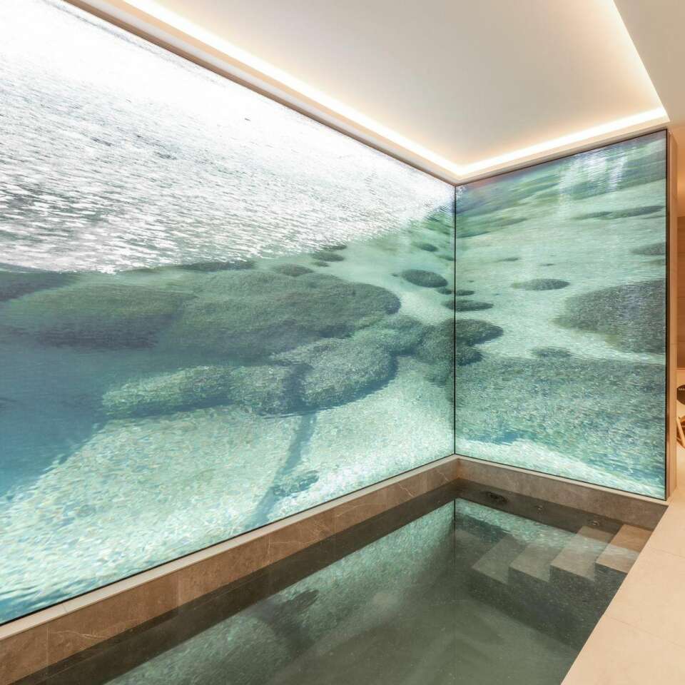 luxury indoor splash pool with decorated walls