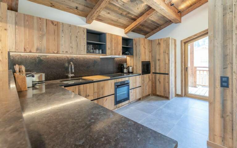 fully-equipped kitchen with access to outdoors