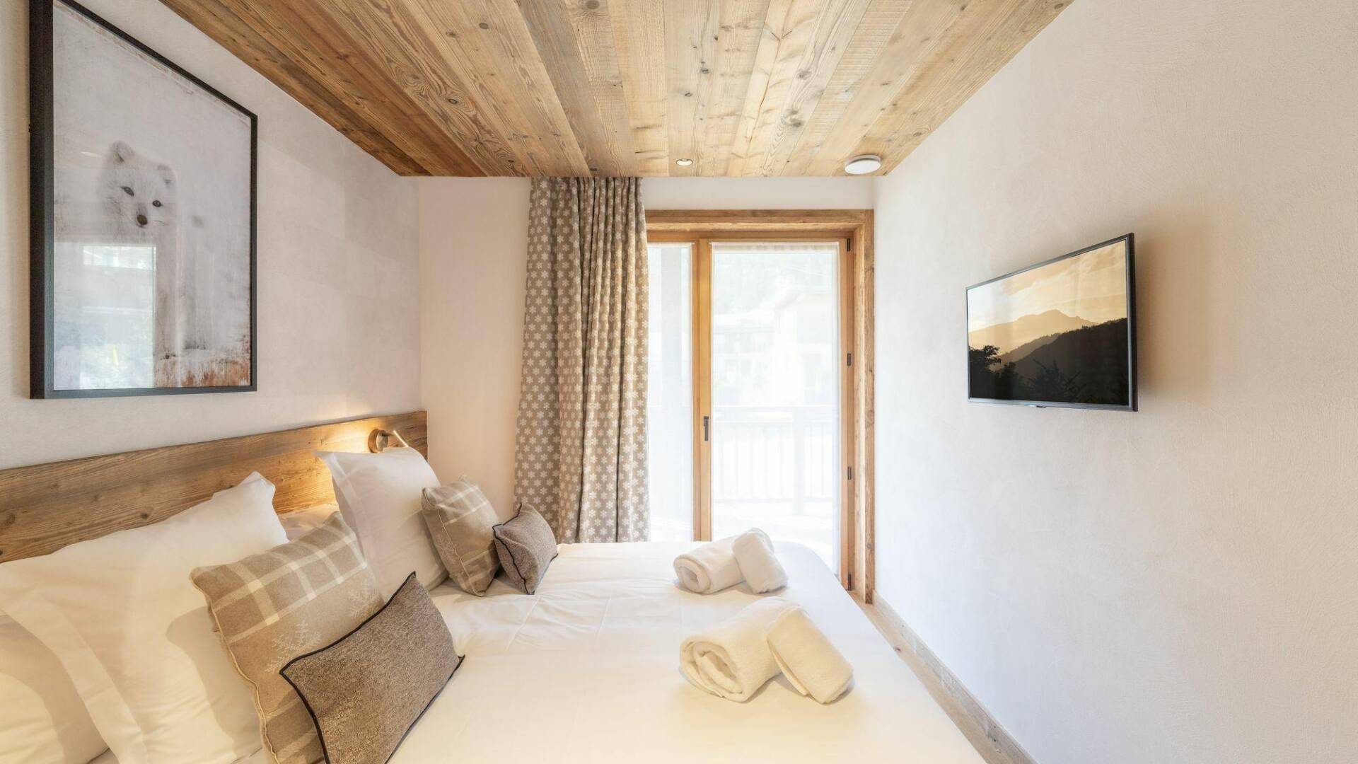 double bedroom with TV and access to outdoors