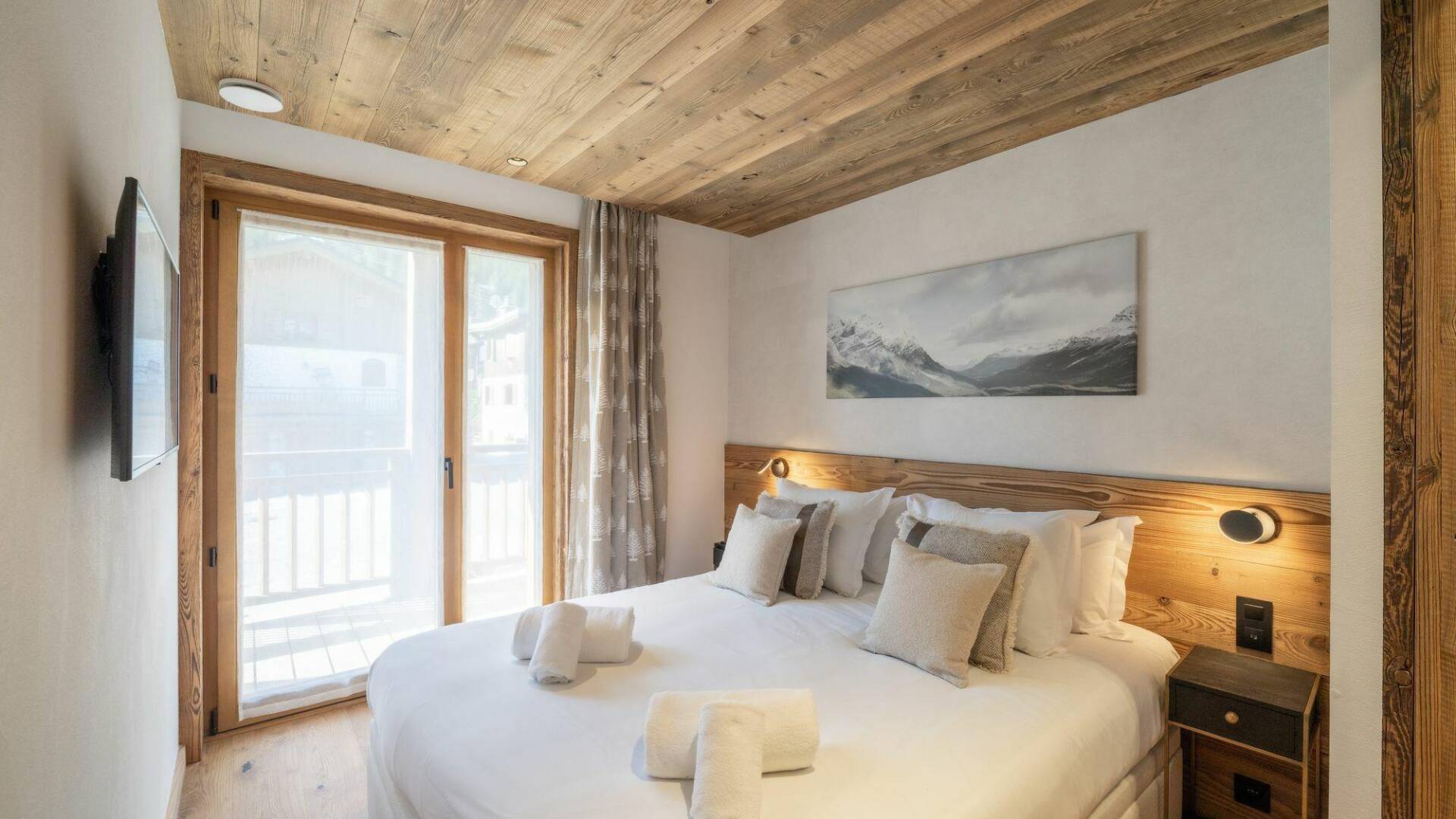 double bedroom with balcony and TV