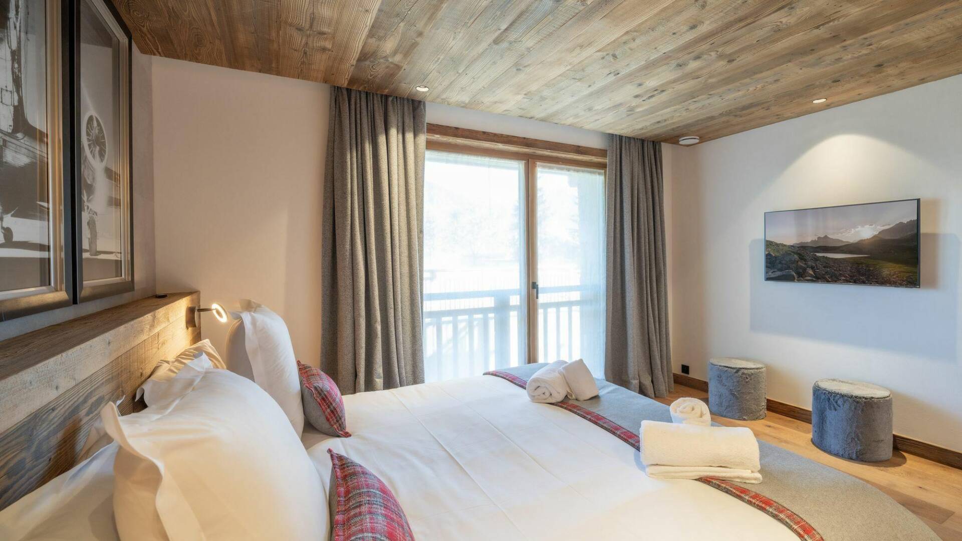 luxury double bedroom with access to balcony and TV