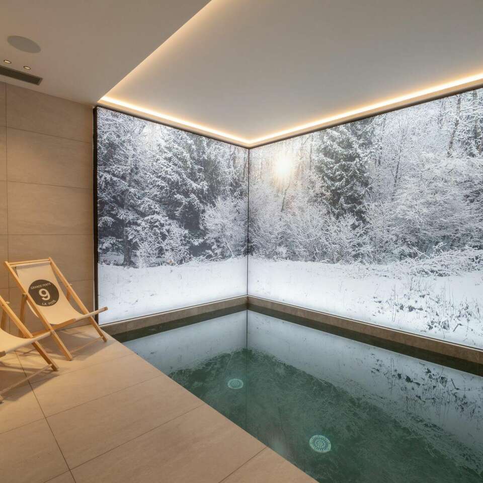 luxury indoor splash pool with decorated wallpaper