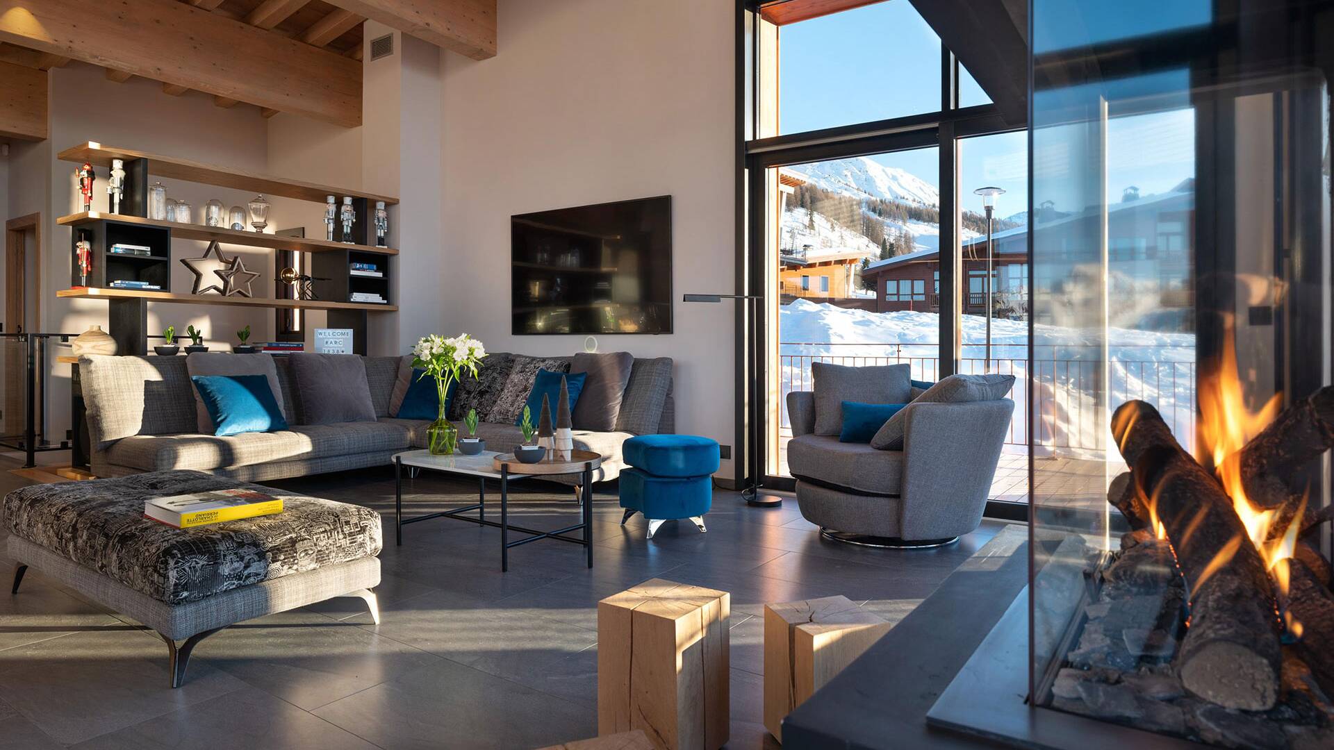 cosy living room with floor-to-ceiling windows and fireplace