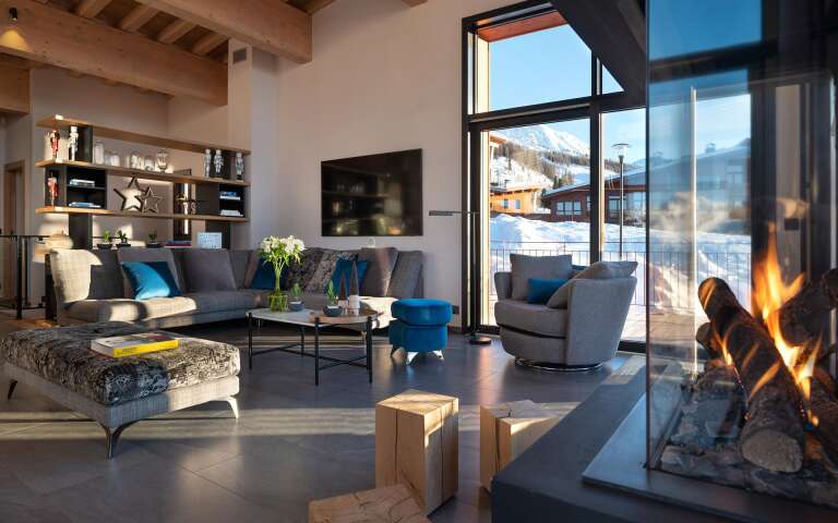 cosy living room with floor-to-ceiling windows and fireplace