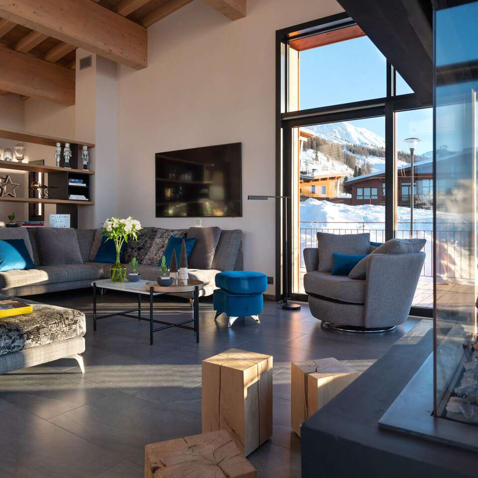 cosy living room with floor-to-ceiling windows and fireplace