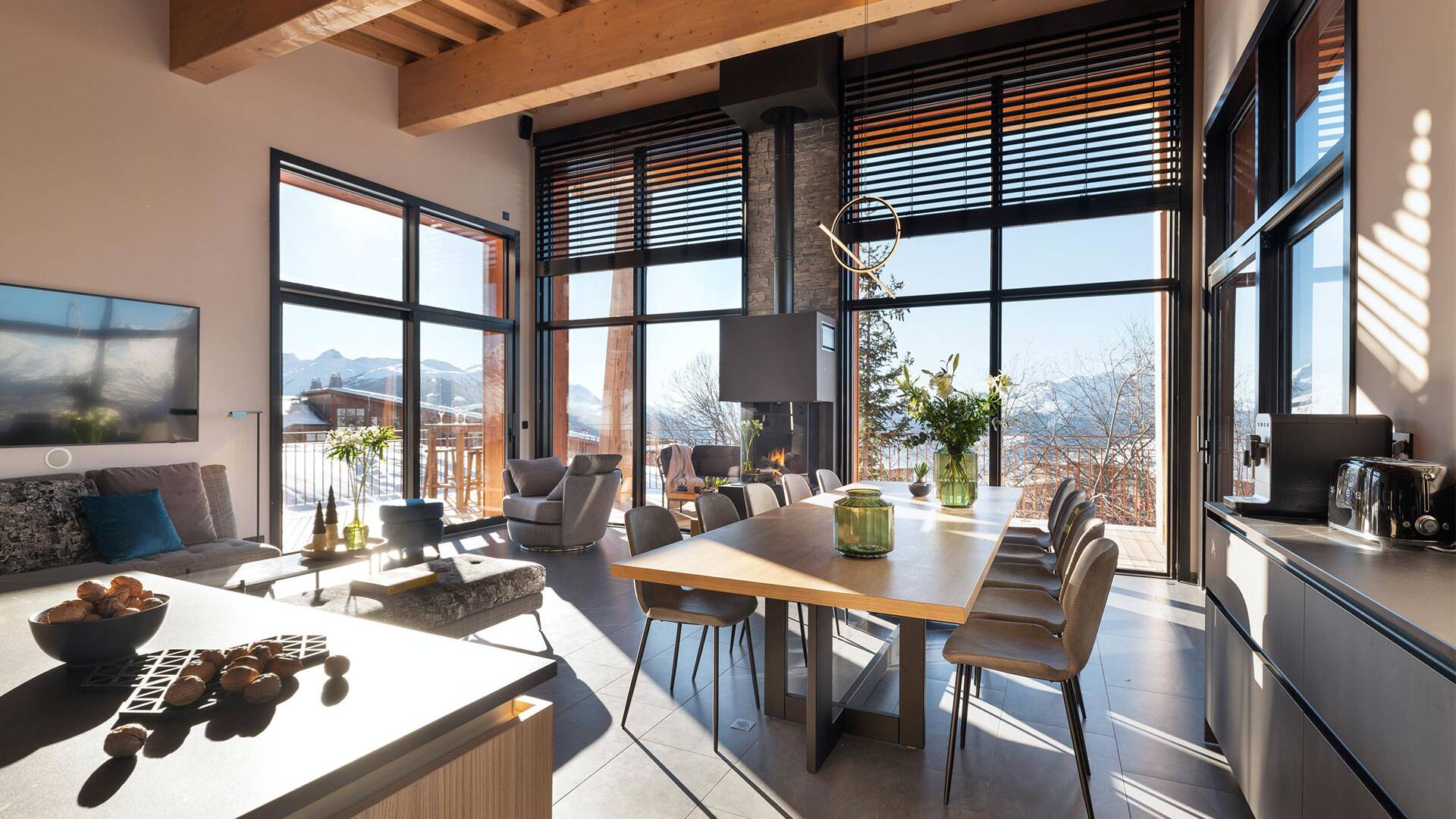 gourmet kitchen and dining table brightened by majestic French windows
