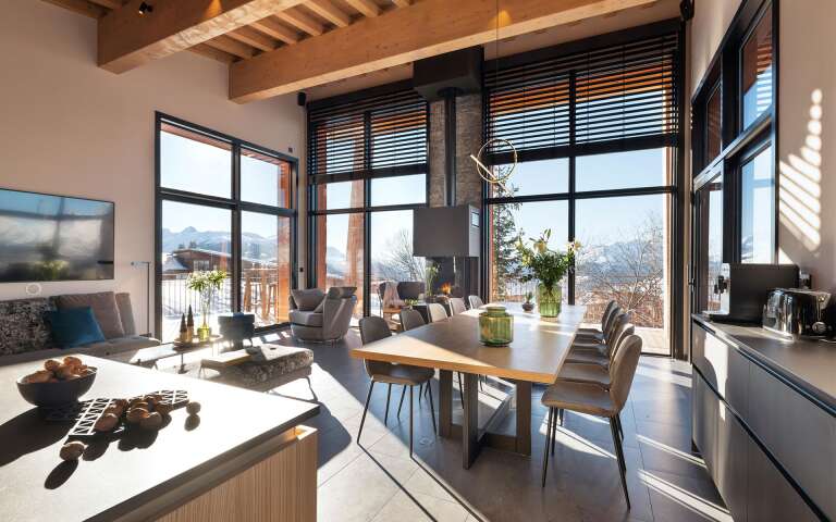 gourmet kitchen and dining table brightened by majestic French windows
