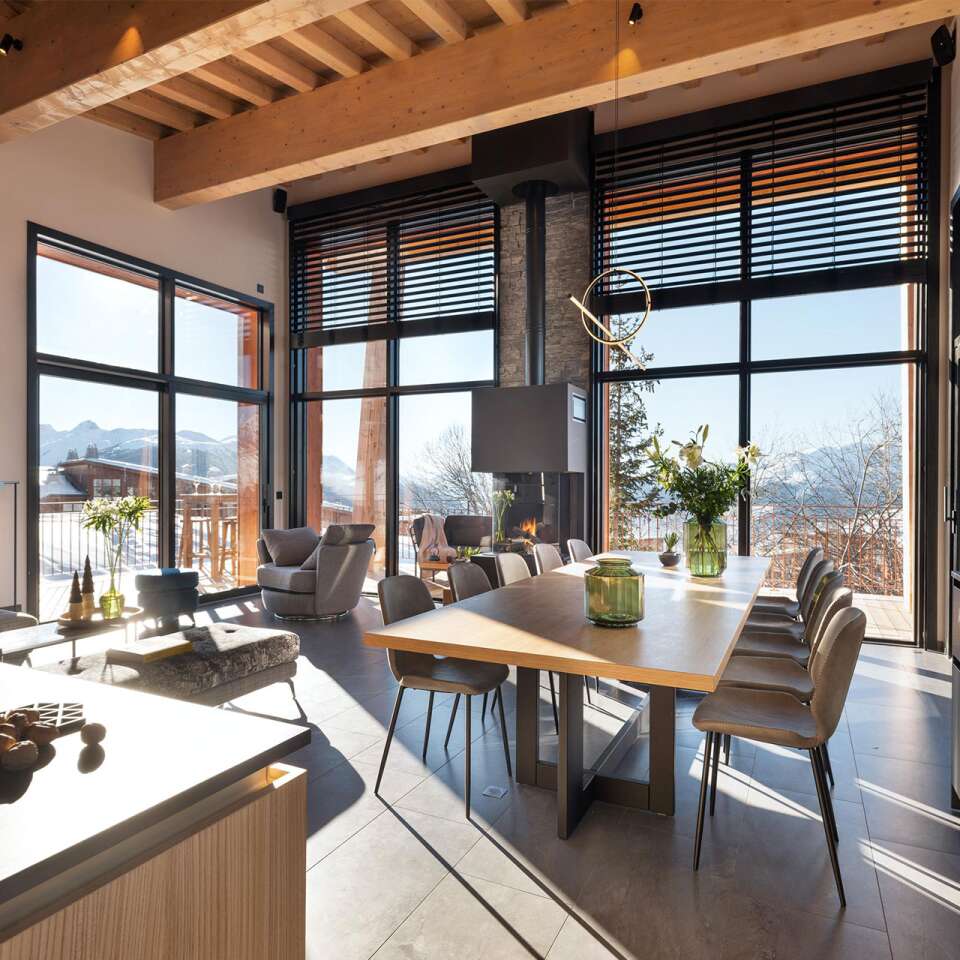 gourmet kitchen and dining table brightened by majestic French windows