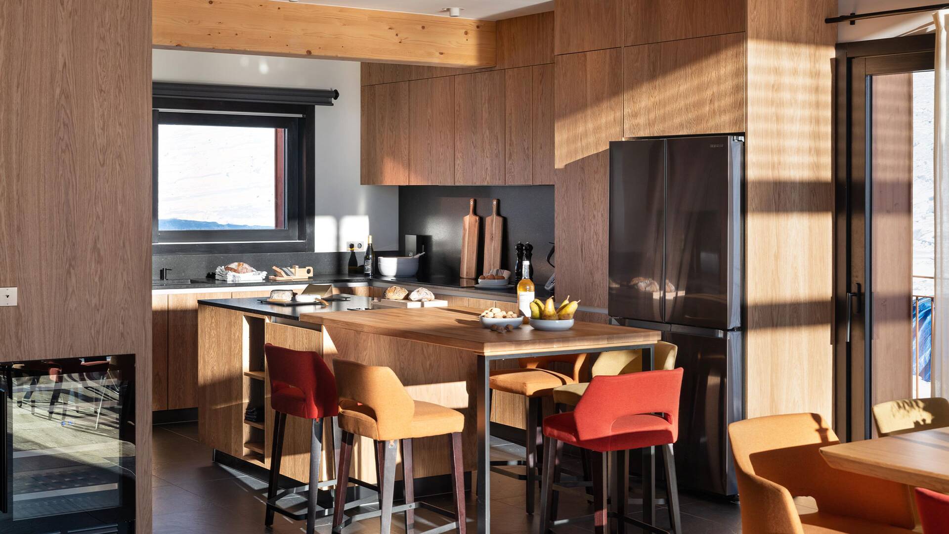 gourmet kitchen with cooking island and stools